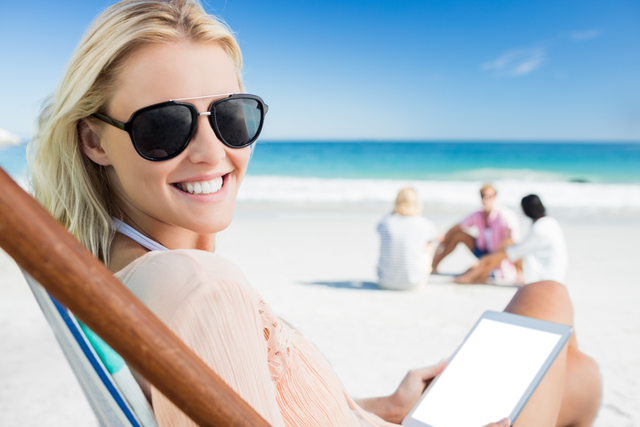 Smiling Woman With Sunglasses Holding Digital Tablet At Transparent Beach - Download Free Stock Videos Pikwizard.com