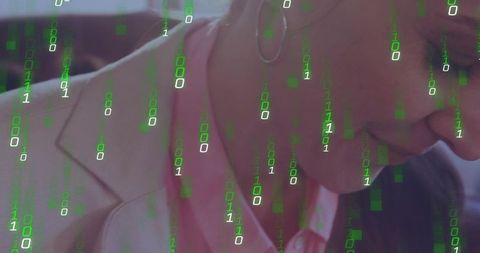 Contemplative mature businesswoman leaning forward at desk with digital binary code overlay