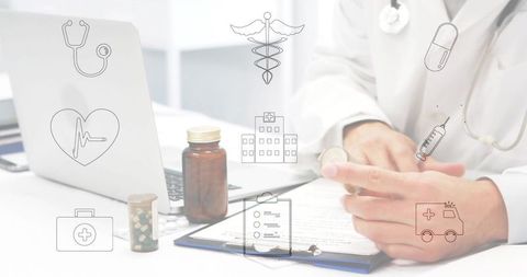 Doctor reviewing medical form with laptop, clipboard and prescription bottles