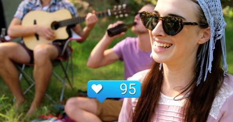 Smiling Woman Enjoying Outdoor Picnic with Friends in Nature