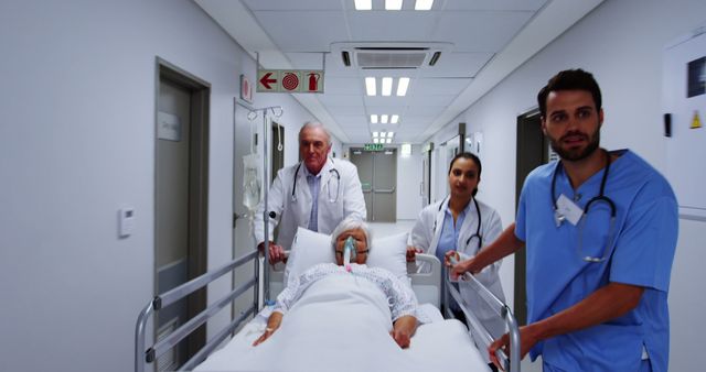 Medical team rushing patient on gurney in hospital corridor - Download Free Stock Images Pikwizard.com