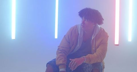 African American Man in Hazy Neon Lit Studio Space