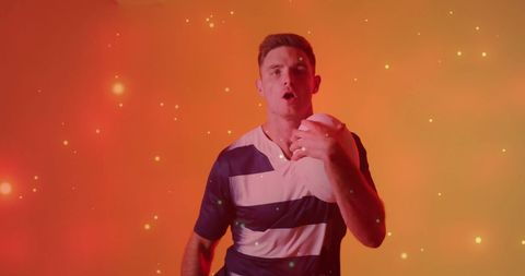 Confident Rugby Player Holding Ball with Bright Background