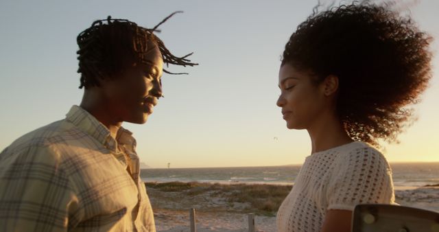 Couple Standing on Beach at Sunset with Wind Blowing Hair - Download Free Stock Images Pikwizard.com