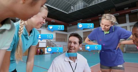Coach Guiding Young Athletes in Gym with Social Media Interaction