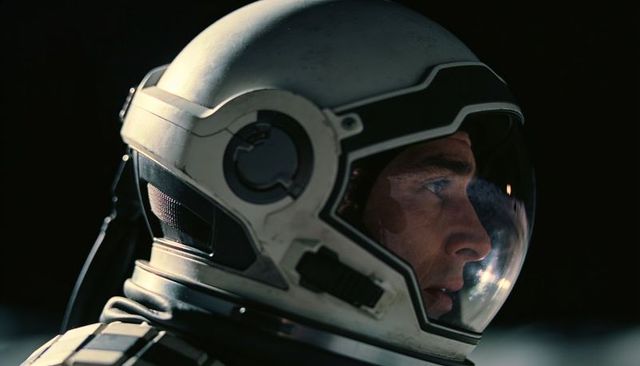 Helmeted astronaut gazing through visor closeup cinematic spacesuit portrait reflective
