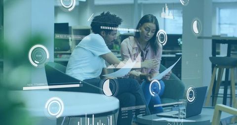 Business colleagues analyzing data in modern office training lounge