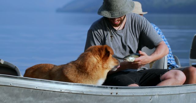 Man and dog sharing a moment on a boat over a serene lake, perfect for illustrating themes of companionship, outdoor activities, fishing, and nature adventures.