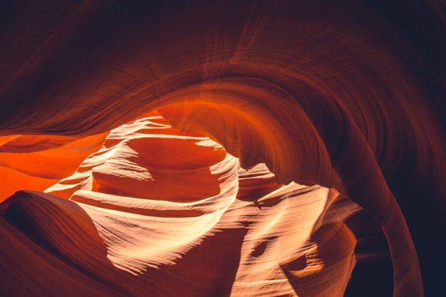 Captures breathtaking sandstone formations in Antelope Canyon located in the American Southwest. Showcases natural erosion and vivid orange hues created by sunlight. Useful for promoting travel destinations, nature photography, geology studies, or scenic landscapes.