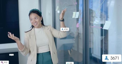 Woman Presenting Strategic Data Analysis in Modern Office