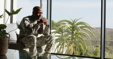 Military Veteran Contemplating Near Sunlit Window