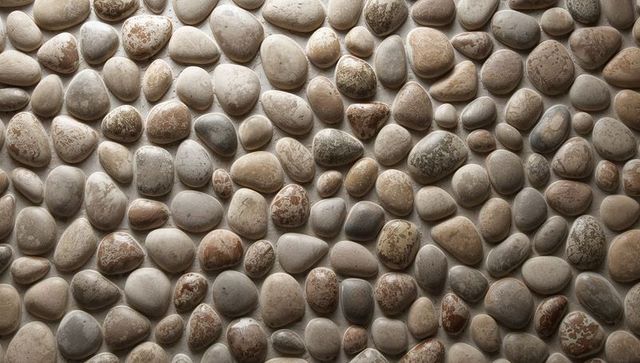 Polished river pebble mosaic flooring with narrow grout and natural stone texture