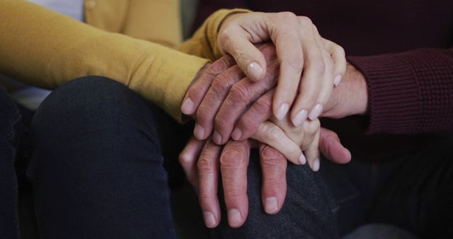 Mid section of senior caucasian couple sitting and holding hands, stacking hands on man's knee - Download Free Stock Photos Pikwizard.com