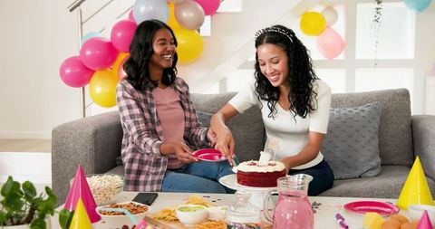 Women Celebrating Birthday with Cake and Balloons Smiling