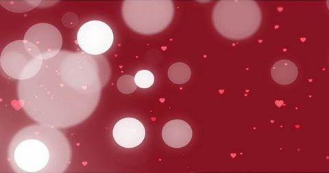 Floating red bokeh orbs and scattered heart particles creating romantic glowing backdrop