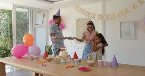 Family Celebrating Birthday at Home with Joyful Decorations