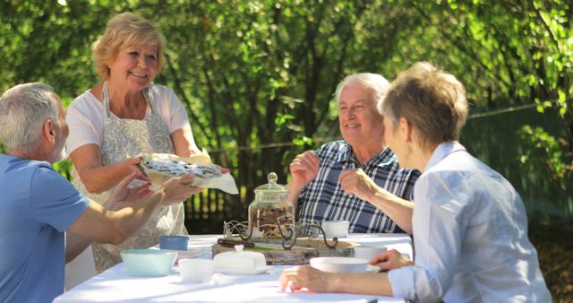 Senior Friends Enjoying Outdoor Tea Party in Garden - Download Free Stock Images Pikwizard.com
