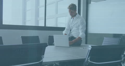 Multitasking Businessman Analyzing Financial Data in Modern Office