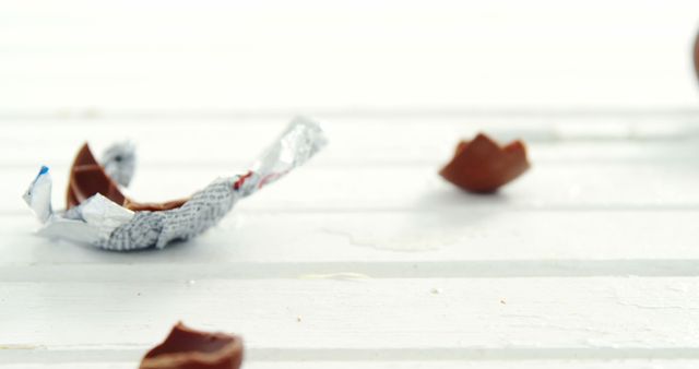 Scattered Chocolates and Wrapping Paper on White Wooden Surface - Download Free Stock Photos Pikwizard.com