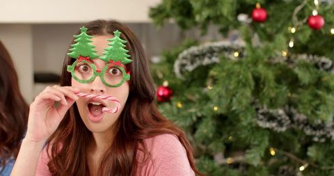 Festive Woman Wearing Tree Glasses Enjoying Holiday Season
