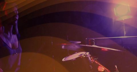 Musician performing on stage with dramatic lighting