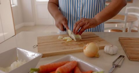 Woman Preparing Fresh Ingredients for Cooking in Modern Kitchen
