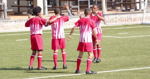 Soccer Team Celebrating During Intense Practice Session