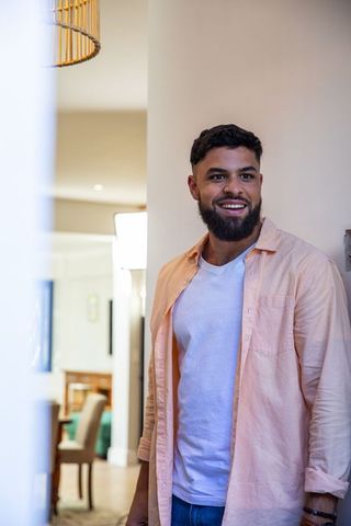 Smiling Man Relaxing in Modern Home Interior
