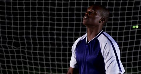 Soccer Player in Action at Night Game