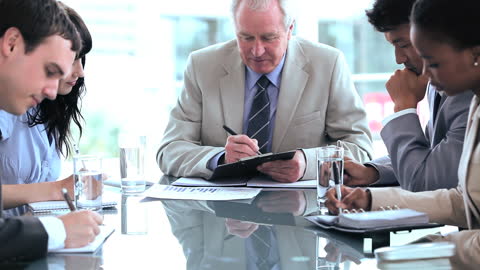 Focused Business Team Collaborating at Modern Office Table