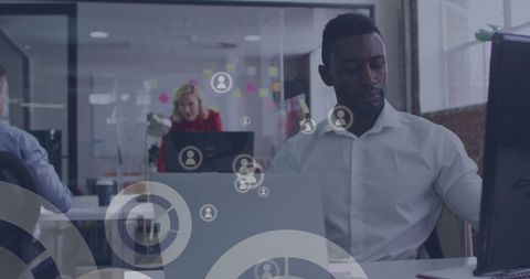 Businessman engaging with digital networks in modern office