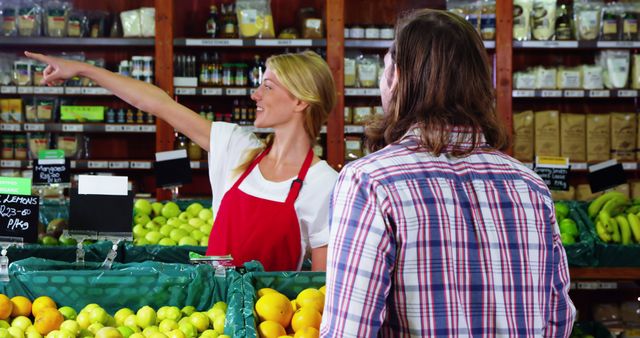 Female grocery store clerk assisting customer with direction - Download Free Stock Images Pikwizard.com