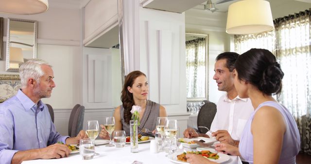 People sharing a meal and engaging in conversation in a fine dining setting suggesting themes of friendship, elegance, social interaction, and good food. Ideal for hospitality, dining experience ads, social gatherings promotions, and luxury lifestyle content.