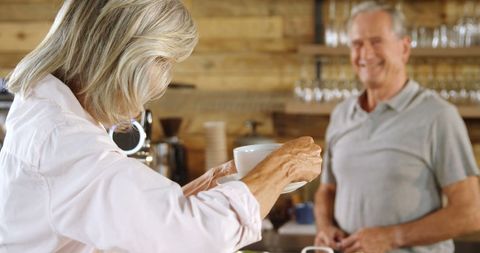 Senior Couple Enjoying Coffee Together in Cozy Cafe