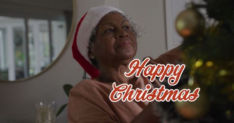 Joyful senior woman decorating with santa hat for christmas