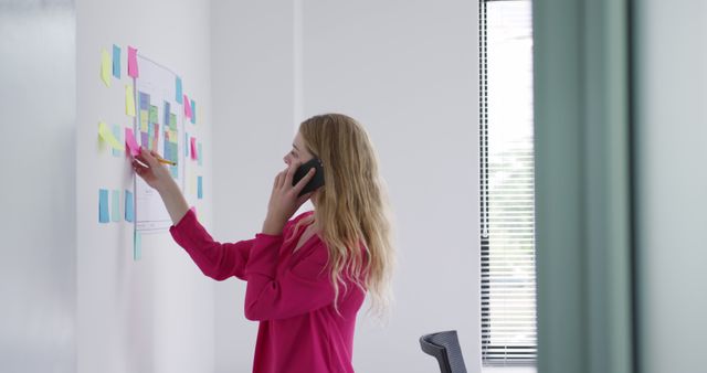 Businesswoman Strategizing with Sticky Notes and Phone Call in Office - Download Free Stock Images Pikwizard.com