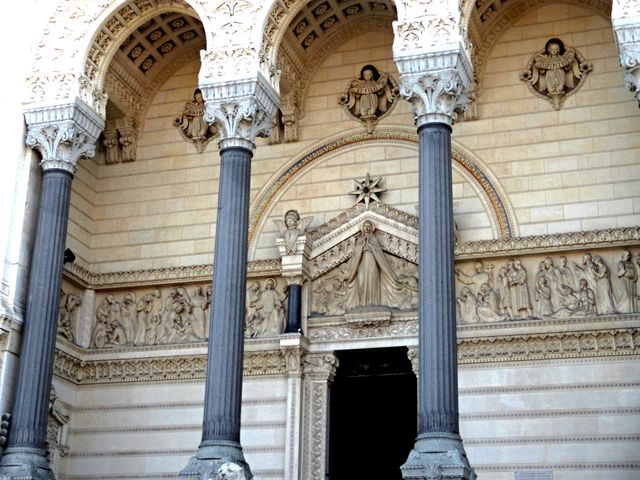 Features detailed carvings on facade of a historic church, including columns, arches, and sculpted figures. Ideal for use in history presentations, architectural studies, cultural heritage projects, and travel guides highlighting European landmarks.