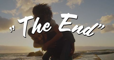 Joyful Couple at Sunset Beach with The End Sign - Download Free Stock Images Pikwizard.com