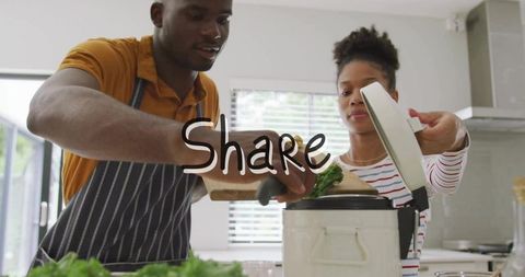 Couple sharing home-cooked meal, man adding chopped herbs to electric cooker in bright kitchen