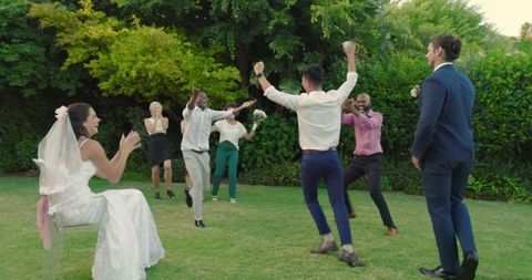 Guests Dancing Joyfully at Outdoor Garden Wedding Celebration