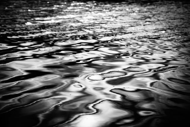 Serene black and white rippling water surface - Download Free Stock Photos Pikwizard.com