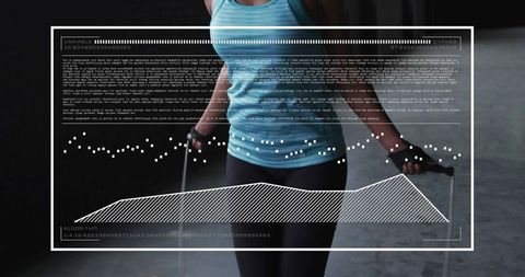 Woman jumping rope in warehouse gym wearing turquoise tank and black leggings with analytics hud
