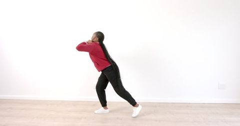 Fit Woman Stretching Indoors for Intense Workout Preparation