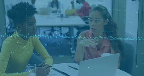 Collaborating Colleagues Reviewing Reports in Modern Office Space