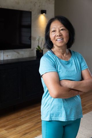 Senior asian woman relaxing in contemporary living room