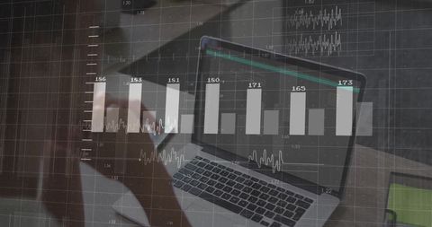 Businesswoman using laptop with data analysis graphics overlay
