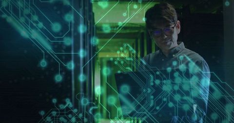 Technician Analyzing Data in Modern Server Corridor