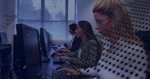 Teamwork in modern office: focused workers typing in computer lab