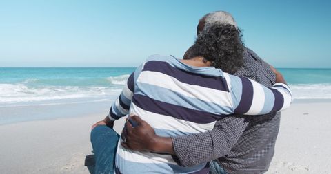 Senior couple embracing on sunny beachfront