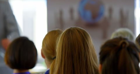 Audience Raising Hand during Business Seminar in Bright Hall